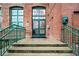 Historic brick building entrance with green door and railings, offering a welcoming approach at 170 Boulevard Se # H412, Atlanta, GA 30312