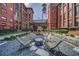 Charming outdoor common area featuring a fireplace, seating, and a water tower in a historic brick building at 170 Boulevard Se # H412, Atlanta, GA 30312