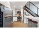 Kitchen, bar, and open staircase in a modern home with stainless steel appliances at 170 Boulevard Se # H412, Atlanta, GA 30312