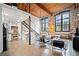 Open-concept living area with exposed brick, wood ceilings, large industrial windows, and stainless appliances at 170 Boulevard Se # H412, Atlanta, GA 30312