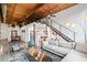 Modern living room with exposed wood ceilings, stainless staircase, and open floor plan at 170 Boulevard Se # H412, Atlanta, GA 30312