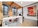 Open concept living room with stainless appliances, wood ceiling, and exposed brick at 170 Boulevard Se # H412, Atlanta, GA 30312