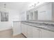 Double vanity bathroom with granite countertops and a soaking tub at 3012 Lexington Ave, Woodstock, GA 30189