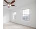 Spacious bedroom with two large windows, ceiling fan, and neutral carpet at 3012 Lexington Ave, Woodstock, GA 30189