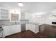 Modern kitchen with white cabinets, granite countertops, and stainless steel appliances at 3012 Lexington Ave, Woodstock, GA 30189