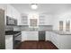 Modern kitchen with stainless steel appliances and white shaker cabinets at 3012 Lexington Ave, Woodstock, GA 30189