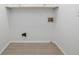 Bright laundry room with white cabinets and wood-look tile floor at 3012 Lexington Ave, Woodstock, GA 30189