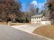 Two-story house with a two-car garage and mature trees at 4925 Erin Rd, Atlanta, GA 30331