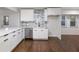 Modern white kitchen with stainless steel appliances and marble backsplash at 4925 Erin Rd, Atlanta, GA 30331