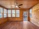 Sunroom with wood paneling, hardwood floors, and ceiling fan at 4925 Erin Rd, Atlanta, GA 30331