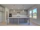 Modern kitchen with gray cabinets, quartz countertops, and an island at 225 Chiswick Loop, Stockbridge, GA 30281