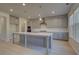 Modern kitchen with gray cabinets, quartz countertops, and an island at 225 Chiswick Loop, Stockbridge, GA 30281