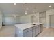 Modern kitchen with gray cabinets, quartz countertops, and island at 225 Chiswick Loop, Stockbridge, GA 30281