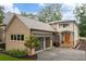 Tan brick home with modern gray garage doors and orange front door at 4225 Maner Se St, Smyrna, GA 30080