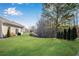 Landscaped backyard with grassy area and trees at 4410 Chaney Ct, Cumming, GA 30028