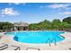 Relaxing kidney-shaped community pool with lounge chairs at 4410 Chaney Ct, Cumming, GA 30028