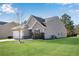 Side view of house showcasing gray siding and landscaping at 4410 Chaney Ct, Cumming, GA 30028