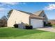 Rear view of house with gray siding, two-car garage, and fenced yard at 4410 Chaney Ct, Cumming, GA 30028