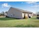 Tan house with green lawn and partial view of backyard at 4410 Chaney Ct, Cumming, GA 30028