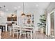 Open concept kitchen and dining area with hardwood floors and modern finishes at 4410 Chaney Ct, Cumming, GA 30028