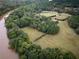 Aerial view of property showing house, pool, and river at 75 Rivercreek Xing, Kingston, GA 30145