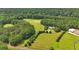 Expansive property featuring a lush green landscape, mature trees, and a stately home with a circular driveway at 75 Rivercreek Xing, Kingston, GA 30145