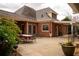 Brick home exterior featuring a large patio area, outdoor furniture, and landscaped garden at 75 Rivercreek Xing, Kingston, GA 30145
