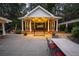Backyard with a gazebo and patio at dusk with ambient lighting, creating a welcoming atmosphere for gatherings at 75 Rivercreek Xing, Kingston, GA 30145