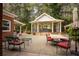 Expansive outdoor living area with a gazebo, dining set, and lounge chairs, perfect for entertaining and relaxation at 75 Rivercreek Xing, Kingston, GA 30145