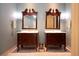 Double vanity bathroom with marble countertops and antique mirrors at 75 Rivercreek Xing, Kingston, GA 30145