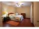 Cozy bedroom with hardwood floors, ceiling fan, and a decorative mirror at 75 Rivercreek Xing, Kingston, GA 30145