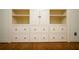 Built-in shelving and drawers in a bedroom with hardwood flooring at 75 Rivercreek Xing, Kingston, GA 30145
