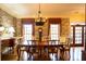 Formal dining room featuring wood table, chairs, hardwood flooring, and decorative wallpaper at 75 Rivercreek Xing, Kingston, GA 30145