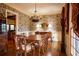 Formal dining room boasts hardwood floors, decorative wallpaper, and elegant wooden furniture at 75 Rivercreek Xing, Kingston, GA 30145