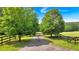 Long private driveway lined with trees leads to a secluded home, offering a sense of tranquility and privacy at 75 Rivercreek Xing, Kingston, GA 30145