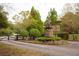 Stone monument sign with 'Riverwood Farm' leading to a private property and gate at 75 Rivercreek Xing, Kingston, GA 30145