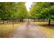 Private gated entrance surrounded by mature trees, offering security and curb appeal at 75 Rivercreek Xing, Kingston, GA 30145