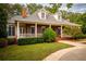 Brick home with a wraparound porch and lush landscaping at 75 Rivercreek Xing, Kingston, GA 30145