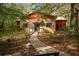 Charming stone and red home with inviting walkway and lush landscaping at 75 Rivercreek Xing, Kingston, GA 30145