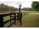 Entrance to a pasture with a bell on a post at 75 Rivercreek Xing, Kingston, GA 30145