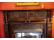 Close up of an ornate, decorative dark wood fireplace surround and marble hearth at 75 Rivercreek Xing, Kingston, GA 30145