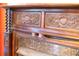 Close up of an ornate, decorative dark wood fireplace surround and marble hearth at 75 Rivercreek Xing, Kingston, GA 30145