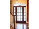Elegant wood front door with sidelights, transom, and gleaming hardwood floors at 75 Rivercreek Xing, Kingston, GA 30145