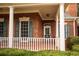 Brick home with a charming front porch and green shutters at 75 Rivercreek Xing, Kingston, GA 30145