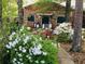 Charming stone and red home featuring a stone path and flowering azaleas at 75 Rivercreek Xing, Kingston, GA 30145