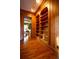 Hallway featuring hardwood floors and custom built-in shelving for elegant storage at 75 Rivercreek Xing, Kingston, GA 30145