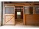 Close up of a wood horse stall with metal bars for ventilation and a wood door at 75 Rivercreek Xing, Kingston, GA 30145