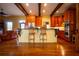 Open kitchen with wood cabinets, granite counters, a breakfast bar, and stainless steel appliances at 75 Rivercreek Xing, Kingston, GA 30145