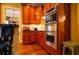 Kitchen with double oven and wood cabinetry at 75 Rivercreek Xing, Kingston, GA 30145