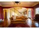Elegant living room with staircase, plush sofa, and hardwood floors at 75 Rivercreek Xing, Kingston, GA 30145